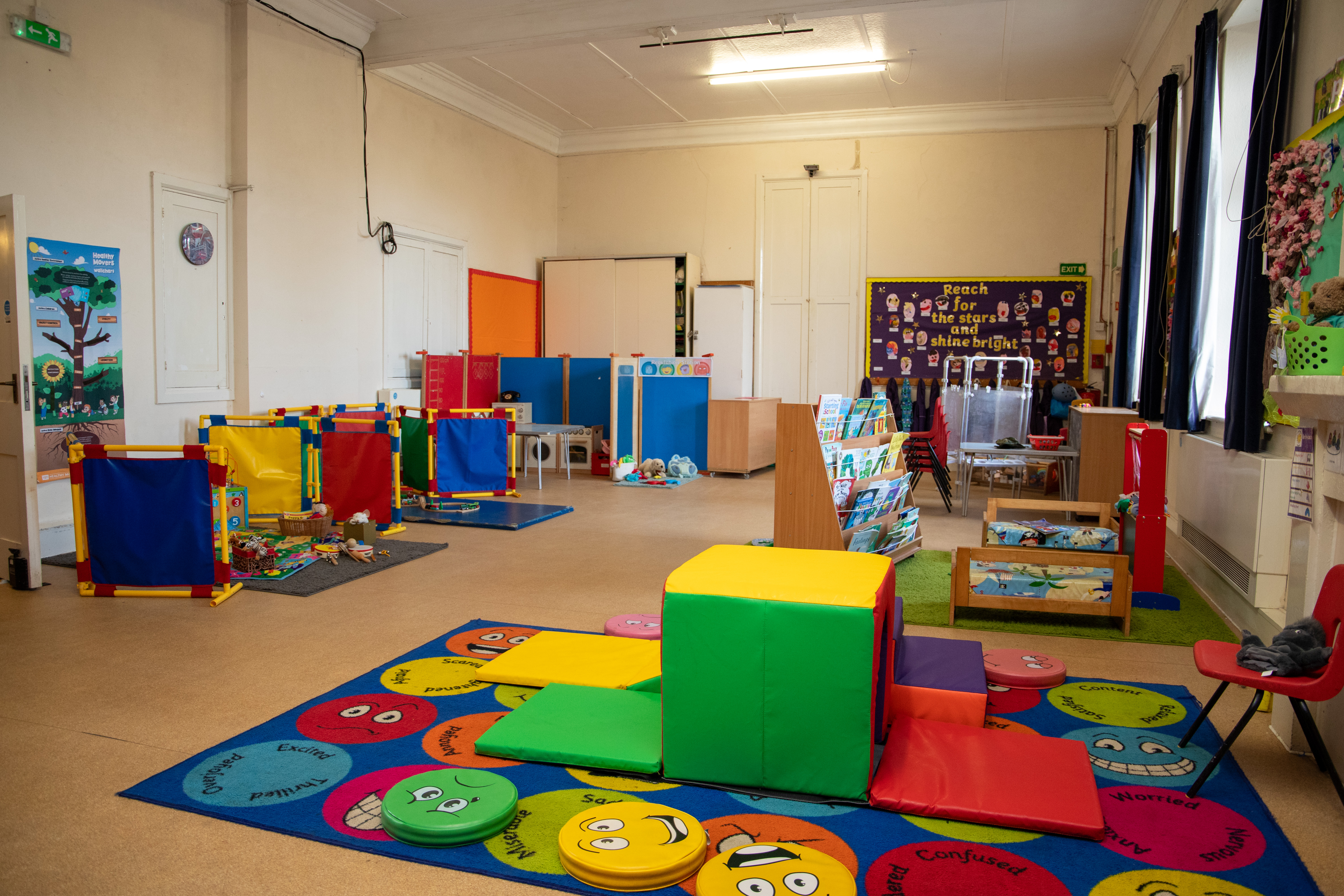 Inside the big playroom — soft-play shapes, the feelings rug and the book corner